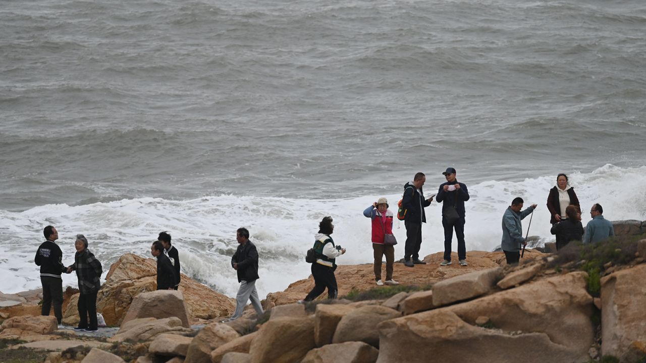 Tourists on the coastline of Pingtan island in China's southeastern province of Fujian on April 7, 2023. 