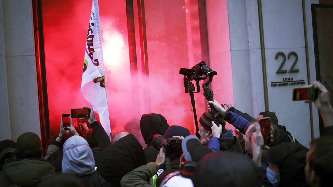 Mandatory Credit: Photo by YOAN VALAT/EPA-EFE/Shutterstock (13868676j)
Various union groups members light flares and occupy the LVMH headquarters before a demonstration against the government pension reform in Paris, France, 13 April 2023. The 'sages', members of the Constitutional Council, are due to deliver their verdict on 14 April concerning the examination of the text of the pension reform, almost one month after the country's prime minister announced the use of article 49.3 of the French Constitution to have the text of the controversial bill to be definitively adopted without a vote. The reform would raise the retirement age in France from 62 to 64.
Pension reform protesters occupy LVMH headquarters in Paris, France - 13 Apr 2023