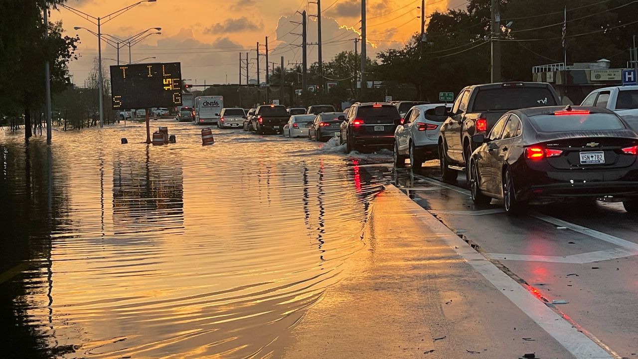 Drivers contend with standing water on roads in Fort Lauderdale Thursday morning.