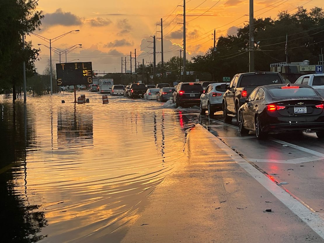 Drivers contend with standing water on roads in Fort Lauderdale Thursday morning.