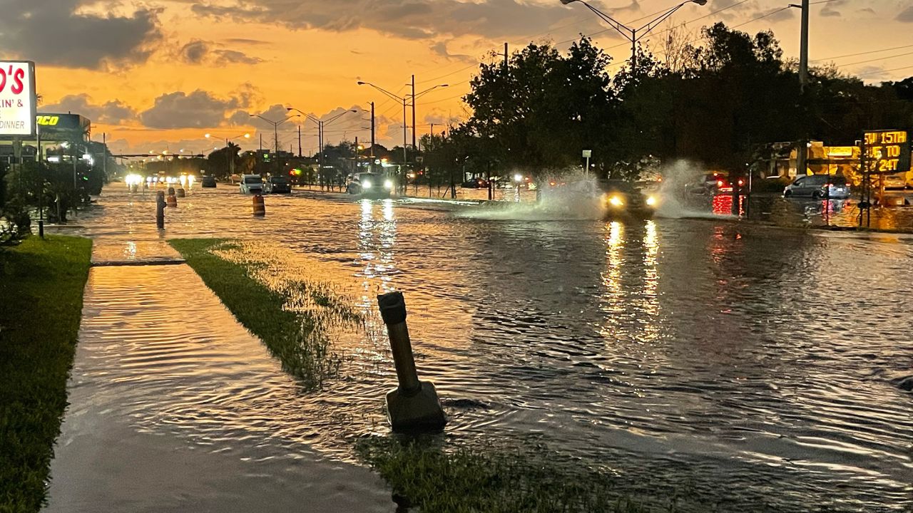 Drivers try to navigate flooded roads in Fort Lauderdale on Thursday morning.