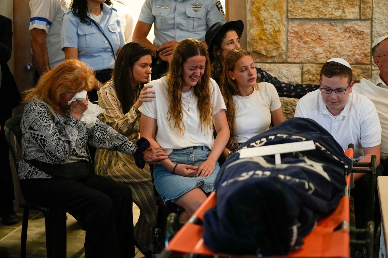 Relatives mourn Maia and Rina Dee at their funeral in Kfar Etzion, West Bank, on Sunday, April 9. The British-Israeli sisters, aged 15 and 20, were killed in a shooting alongside their mother that Israeli Prime Minister Benjamin Netanyahu condemned as a 