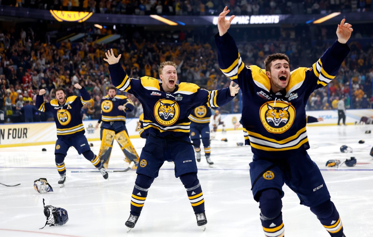 CJ McGee, Joey Cipollone and other members of the Quinnipiac University hockey team celebrate after winning the national championship on Saturday, April 8. It is the program's first national title.