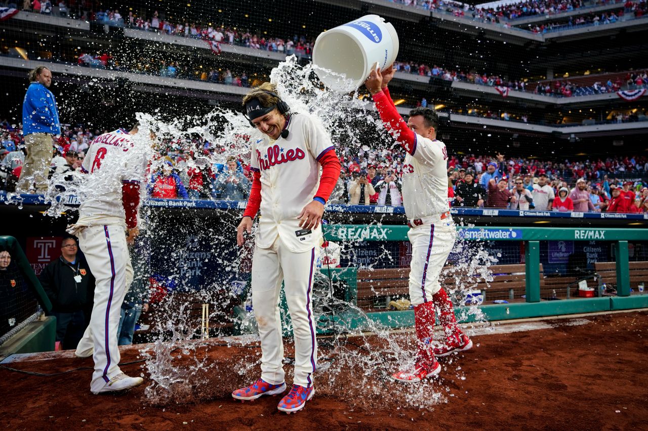 Kyle Schwarber douses Philadelphia Phillies teammate Bryson Stott after Stott hit a walk-off single to defeat Cincinnati in a Major League Baseball game on Saturday, April 8.