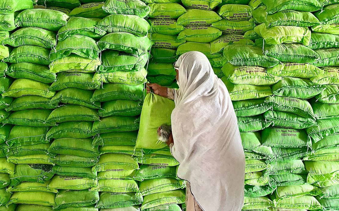 A woman takes a bag of free flour at a government run distribution center in Islamabad.