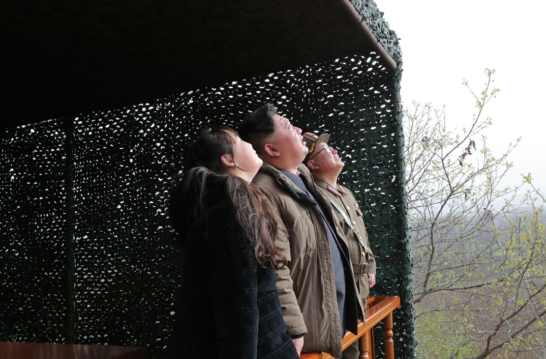 Kim Jong Un, center, and his daughter, left, watch Thursday's missile launch in a photo released by state media.