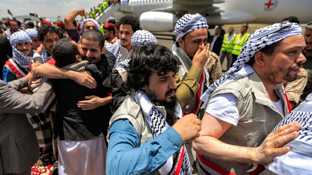 Returned Houthi prisoners exchanged in a deal with Yemen's internationally recognized government are greeted upon arrival at Sanaa International Airport on Friday.