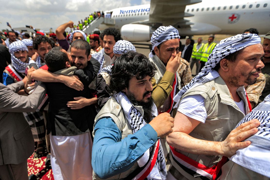 Returned Houthi prisoners exchanged in a deal with Yemen's internationally recognized government are greeted upon arrival at Sanaa International Airport on Friday.