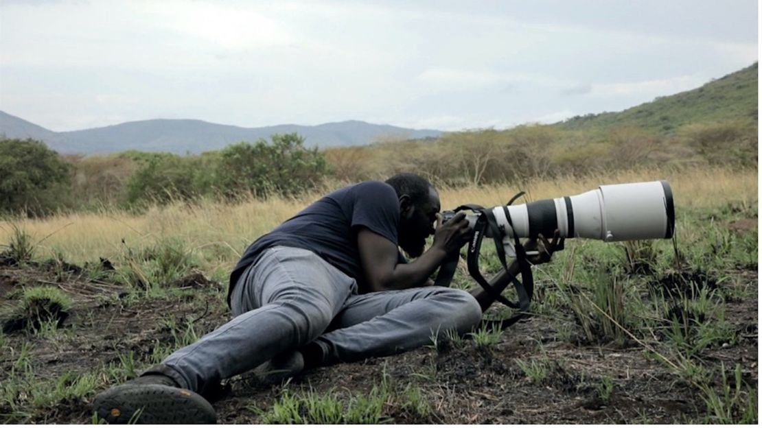 Photographer Anthony Ochieng Onyango in action during a trip to Ruma National Park in Kenya, searching for the elusive roan antelope. 