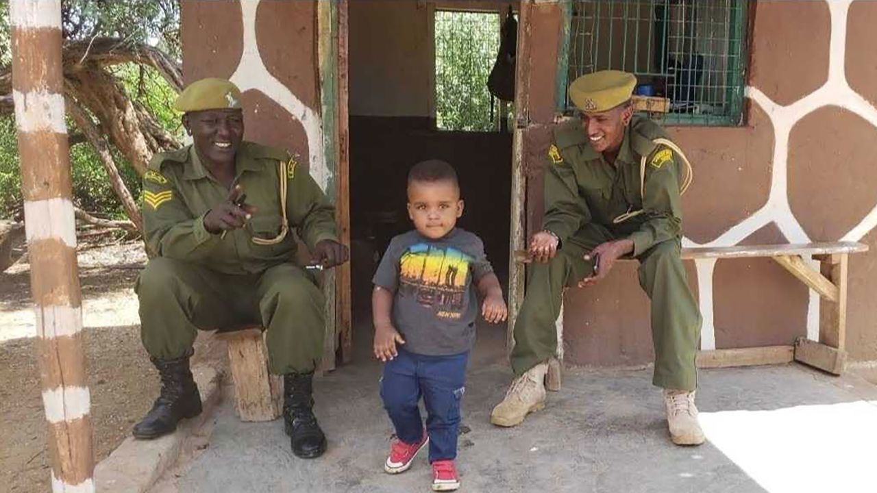 Faith Karimi's son Liam visits with wildlife park rangers at the Samburu National Reserve in Kenya.