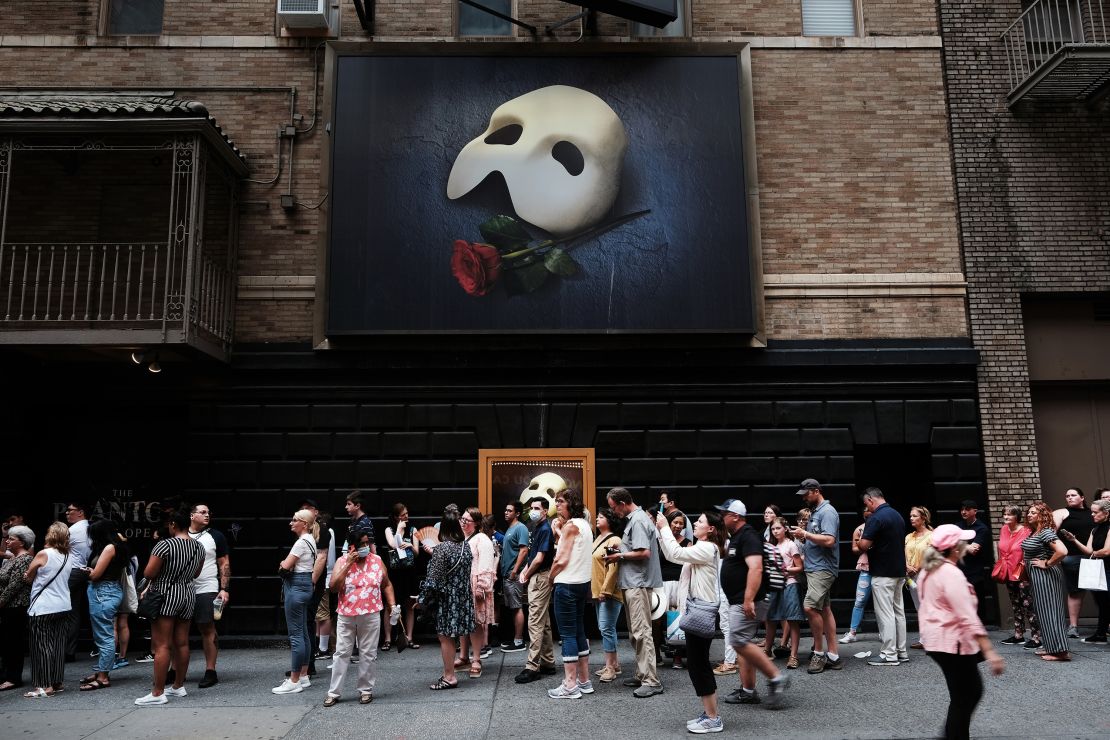 People wait in line to see "Phantom of the Opera" in midtown Manhattan as temperatures entered the 90s on July 21, 2022 in New York City.