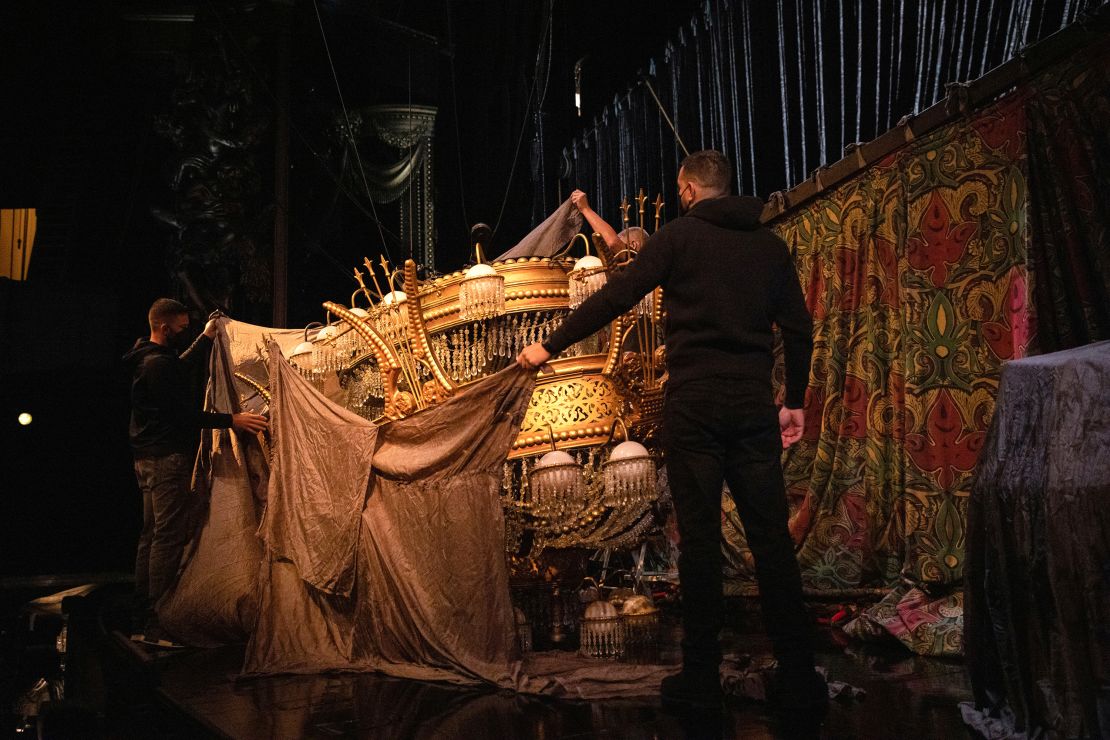 Stagehands uncover the chandelier during preparations to reopen "Phantom of the Opera" at the Majestic Theater in New York on September 28, 2021.