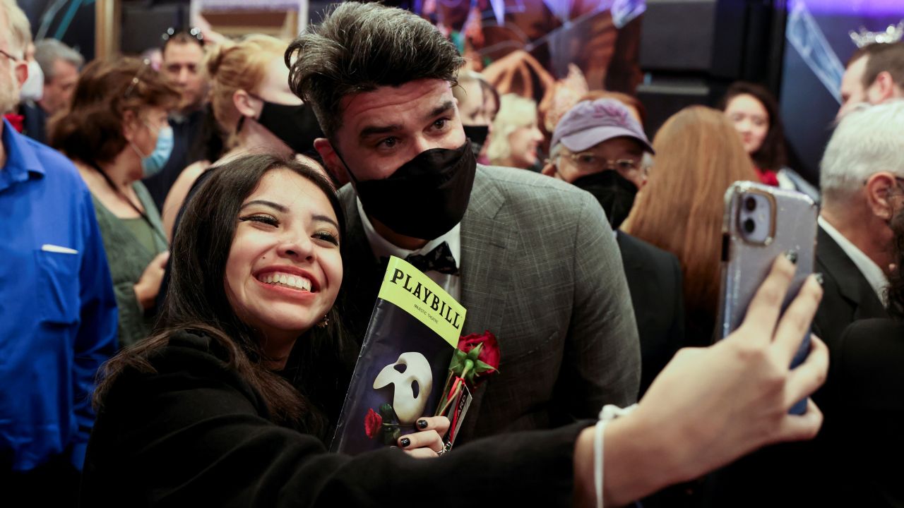 Actor Ben Crawford, who plays the Phantom, takes a selfie with a fan after performing on the reopening night of "Phantom of the Opera" at the Majestic Theater in New York City on October 22, 2021.
