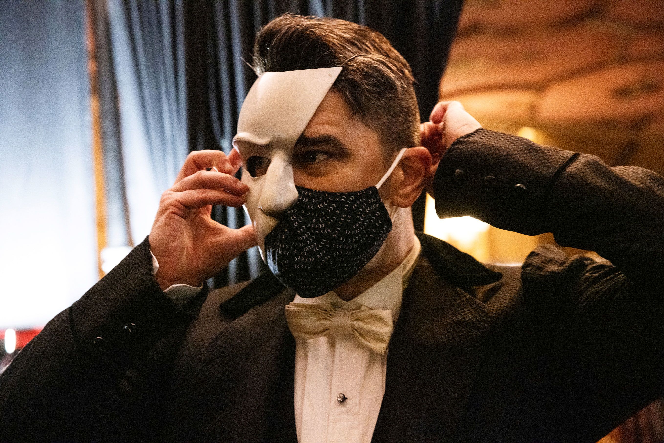 Actor Ben Crawford wears the phantom mask and a face mask during a fitting in 2021.