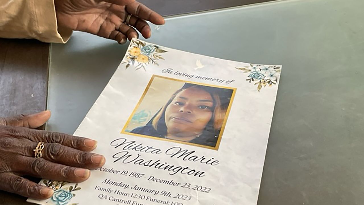 Patricia Pouncey holds a flyer with service information for her late daughter, Nikita Washington, on April 14, 2023.