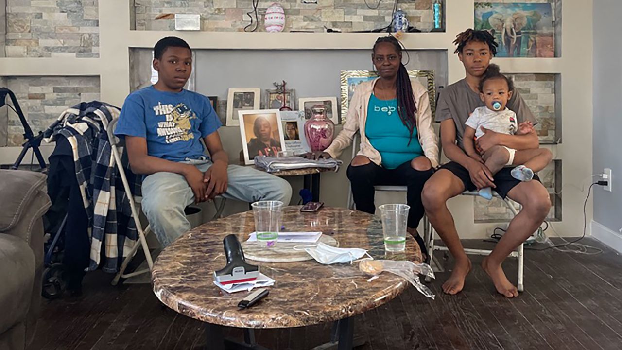Patricia Pouncey, center, sits with her grandchildren, Jessie, left, and Antonio, right, holding Noah on April 14, 2023. 