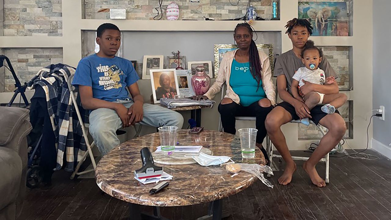 Patricia Pouncey, center, sits with her grandchildren, Jessie, left, and Antonio, right, holding Noah on April 14, 2023.