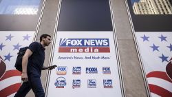 A person walks past the Fox News Headquarters in New York, Wednesday, April. 12, 2023.