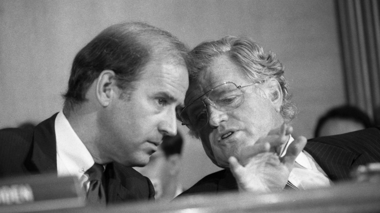 Then-Sen. Joe Biden, left, confers with then-Sen. Ted Kennedy during a Supreme Court confirmation hearing for William Rehnquist. 