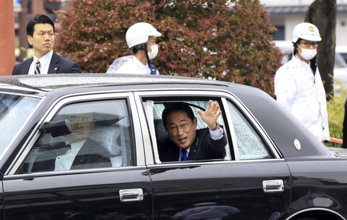 Japan's Prime Minister Fumio Kishida waves as he leaves Wakayama station after delivering his speech on April 15, 2023. 