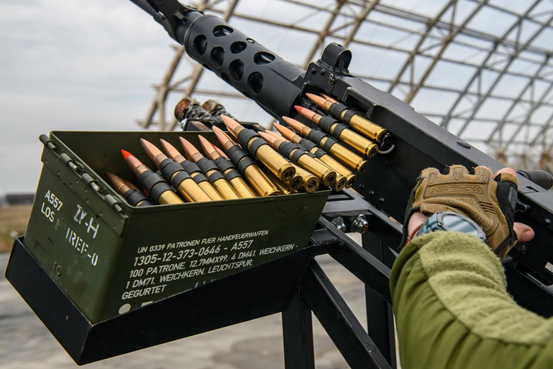 A member of Ukraine's mobile air defense group, or so-called drone hunters, checks a  Browning machine gun on top of a pick up truck at the Hostomel airfield near Kyiv, Ukraine, on April 1, 2023.