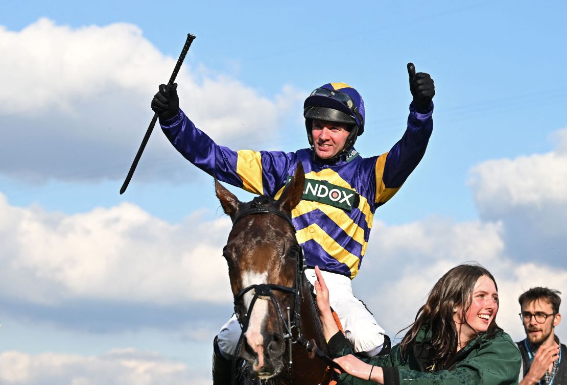 Jockey Derek Fox celebrates after riding Corach Rambler to victory in the Grand National. 