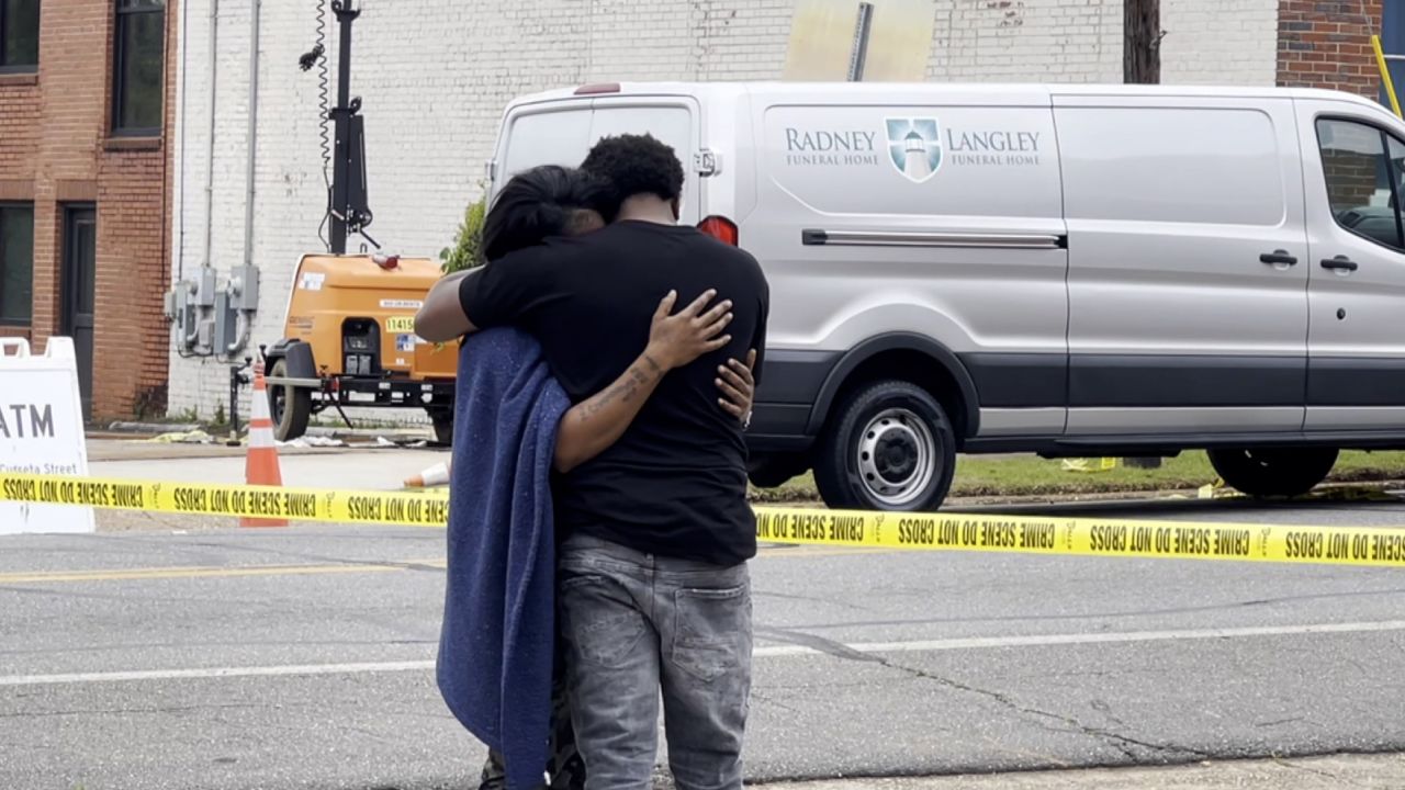 Mourners grieve near the site of the mass shooting where more than a dozen teens were shot.