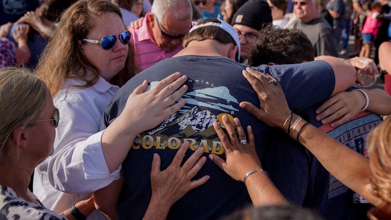 Community members embrace each other during a vigil the day after a shooting during a teenager's birthday party at Mahogany Masterpiece Dance Studio in Dadeville, Alabama, U.S., April 16, 2023. REUTERS/Cheney Orr