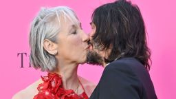 Alexandra Grant and Keanu Reeves share a kiss on the red carpet at the Museum of Contemporary Art Gala in Los Angeles.
