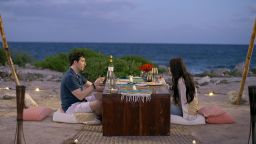Love is Blind's Zach and Irina sit for dinner in a recent episode.  