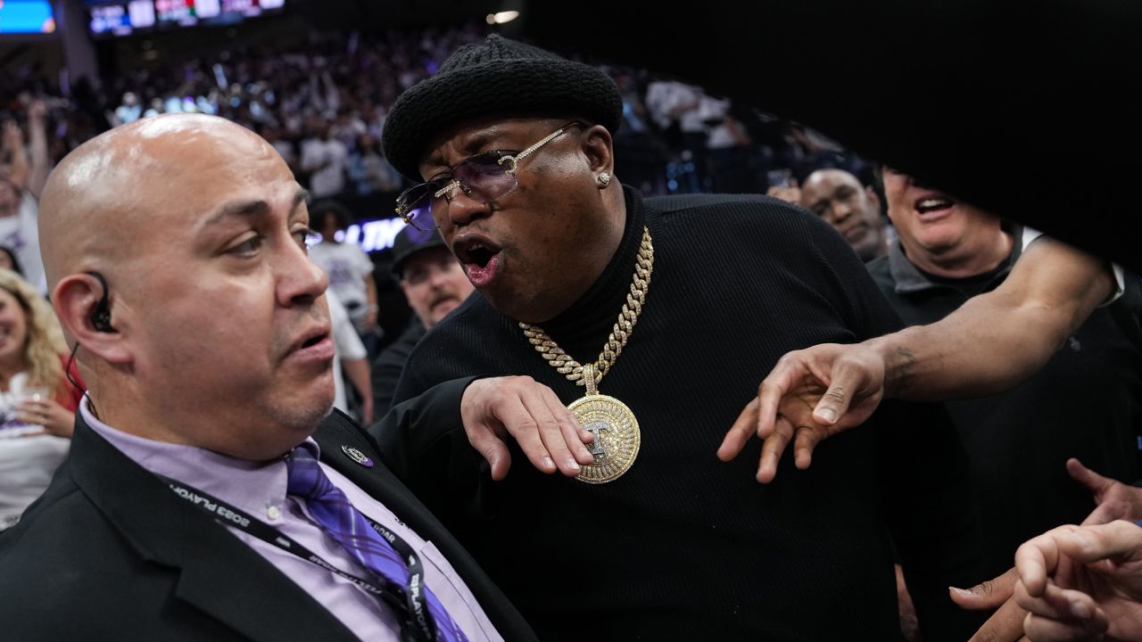 Earl 'E-40' Stevens talks to security personnel before being escorted from courtside during Game 1 of the Western Conference first round playoffs between the Golden State Warriors and Sacramento Kings on April 15.