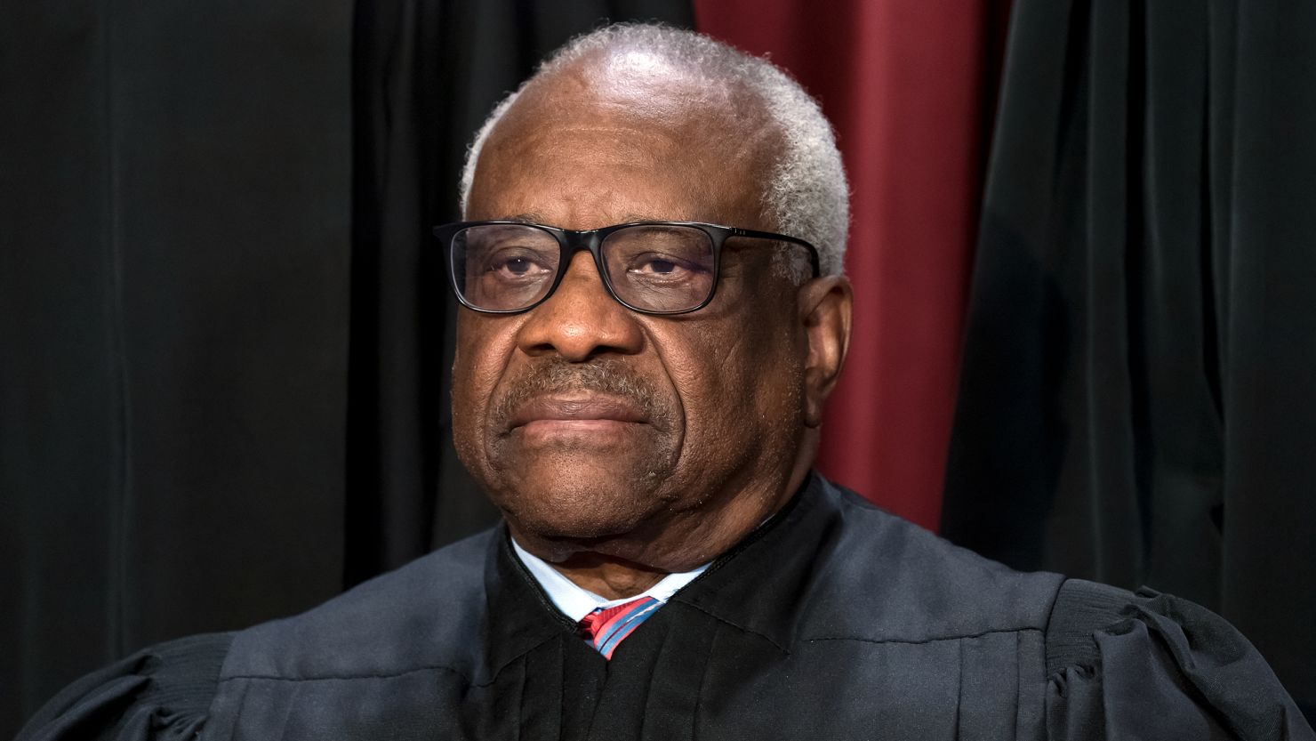 Associate Justice Clarence Thomas joins other members of the Supreme Court as they pose for a new group portrait, at the Supreme Court building in Washington, DC, in October 2022.