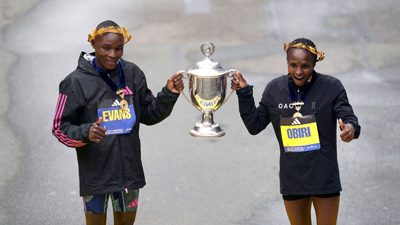 Evans Chebet, left, and Hellen Obiri, both of Kenya, pose on the finish line after winning the men's and women's division of the Boston Marathon, Monday, April 17, 2023, in Boston. (AP Photo/Charles Krupa)