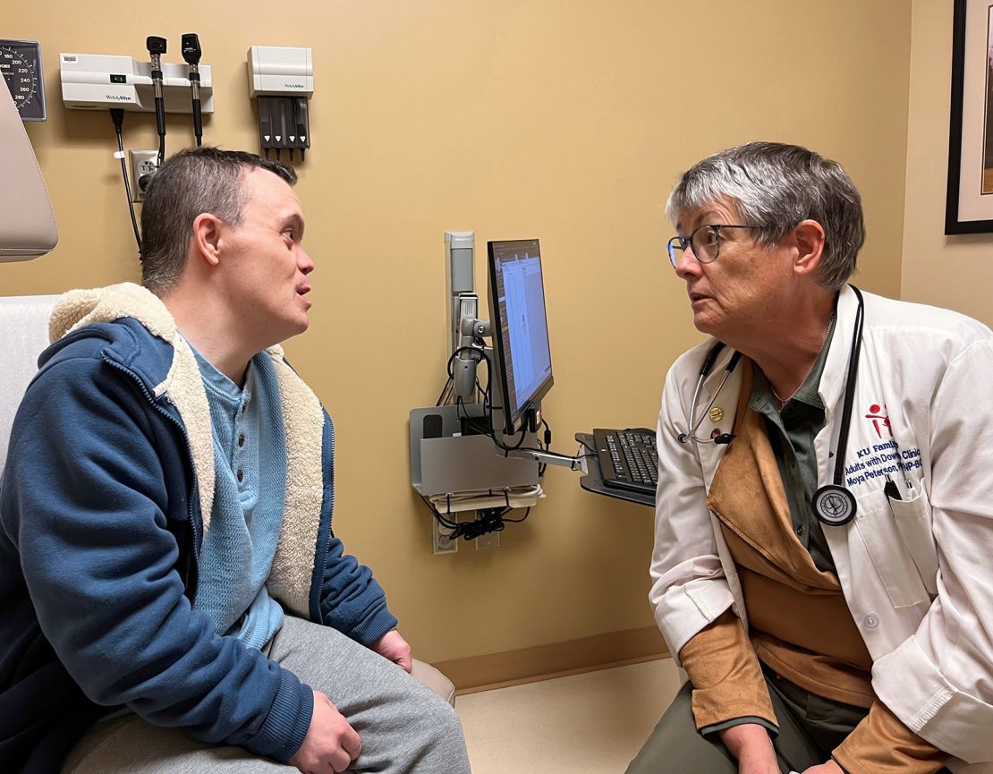 Nurse practitioner Moya Peterson speaks to Christopher Yeo of Hartford, Kansas. Peterson leads an rare clinic for adults with Down syndrome. 