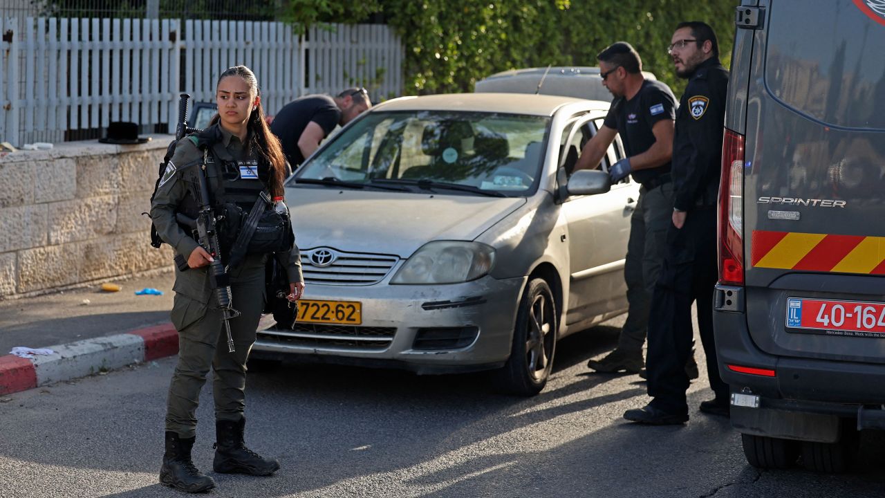 Israeli security forces inspect a vehicle at the scene of a shooting attack in Sheikh Jarrah on Tuesday. 