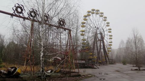 Swings and a ferris wheel remain in an abandoned amusement park of Pripyat, Ukraine. 