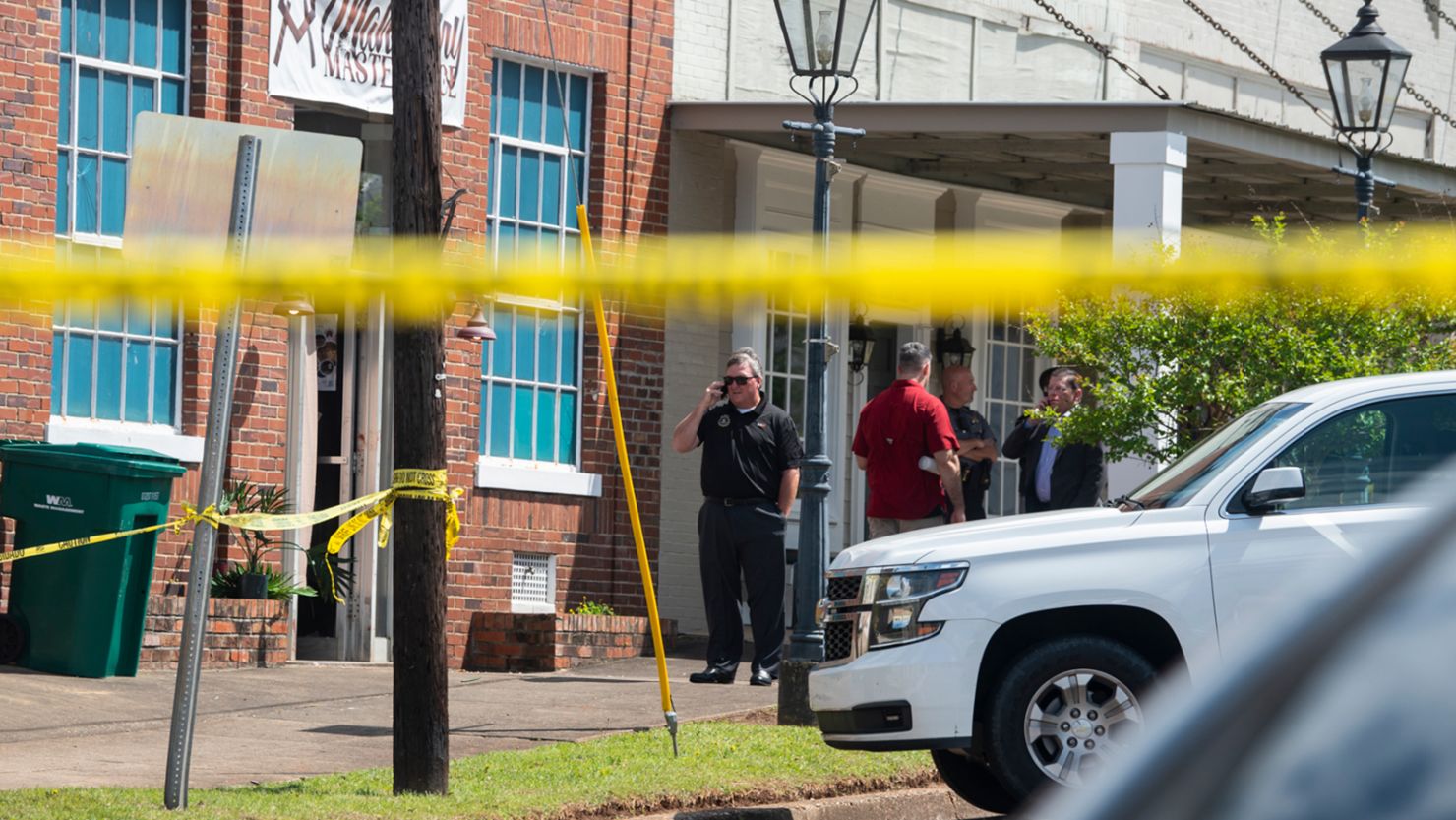 Law enforcement officers investigate the day after the April 15 shooting at a venue in downtown Dadeville, Alabama.