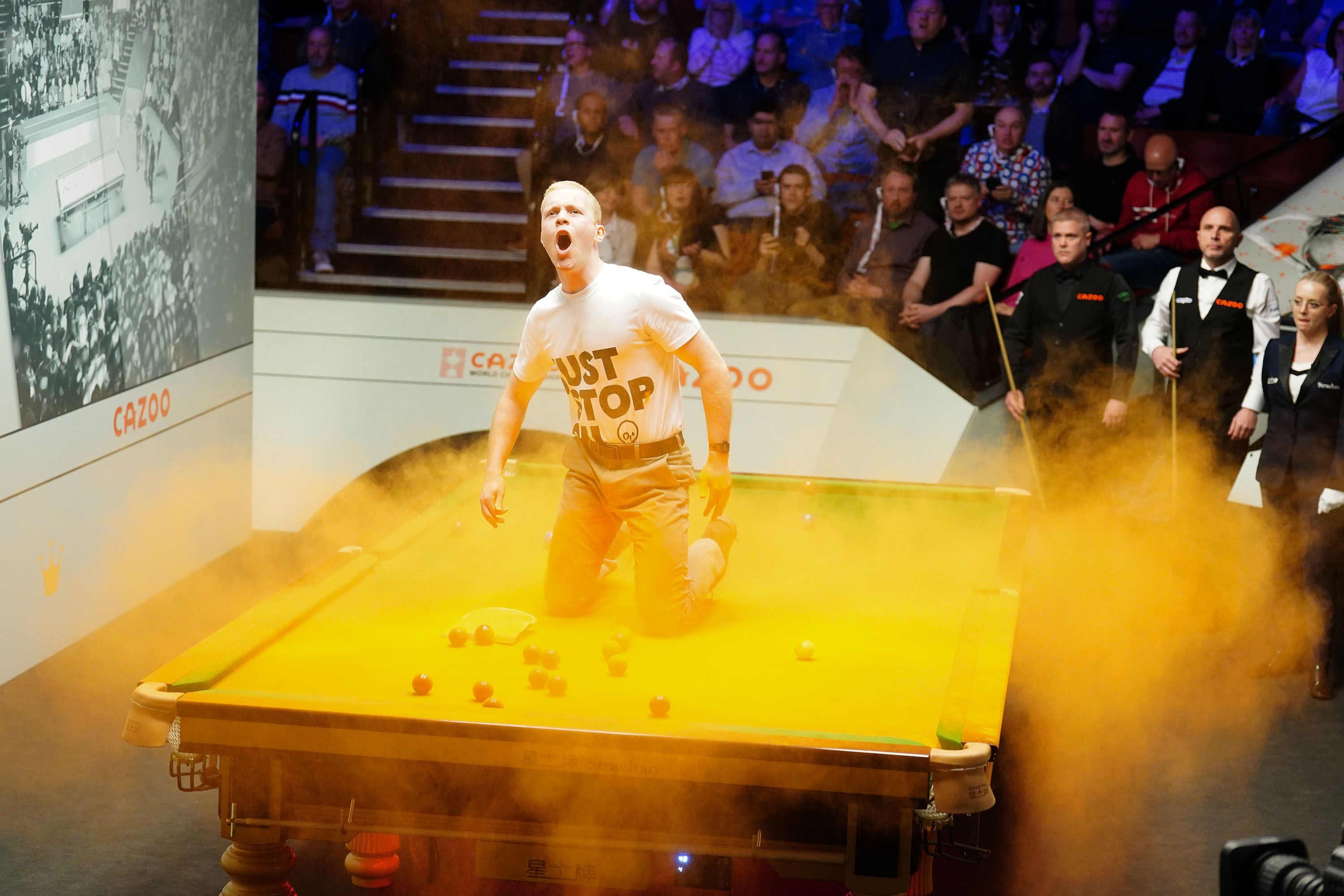 Just Stop Oil protester disrupts World Snooker Championship by throwing  orange powder paint on table | CNN