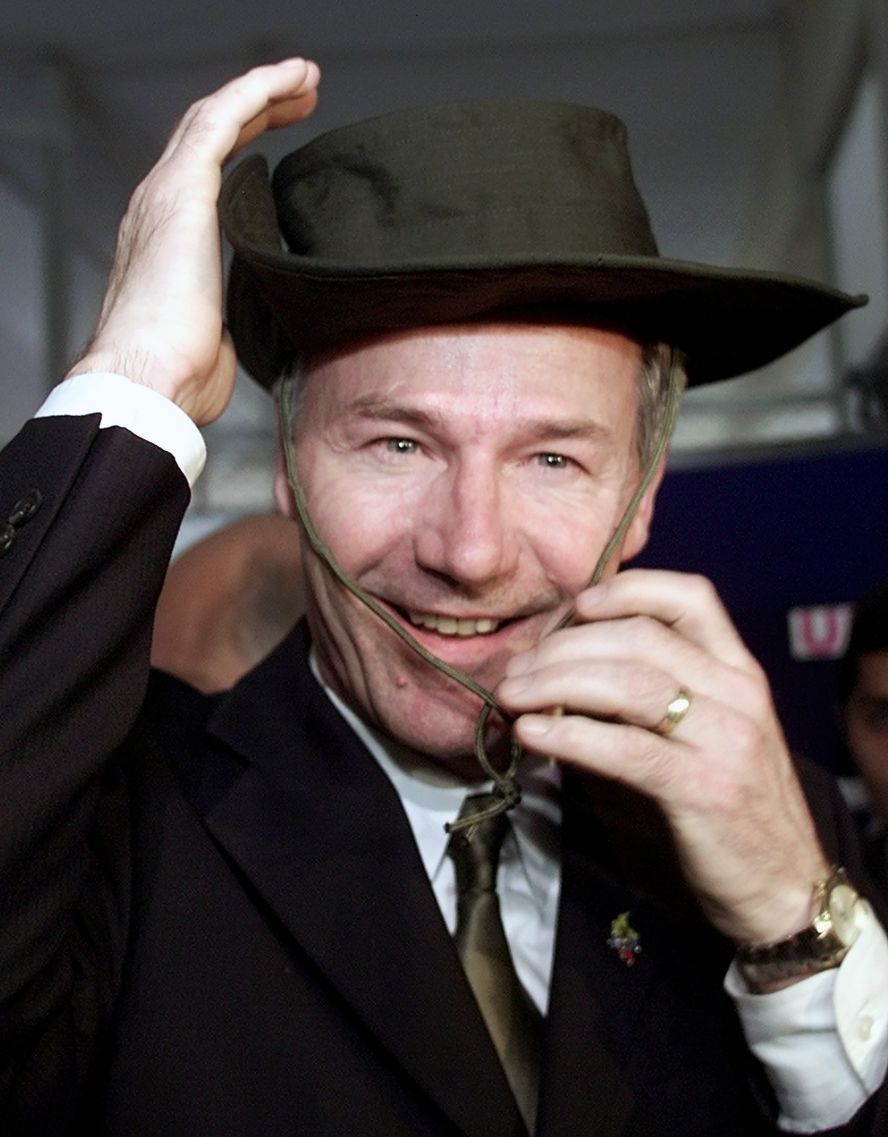 Hutchinson puts on a police hat while visiting police headquarters in Bogotá, Colombia, in March 2002.