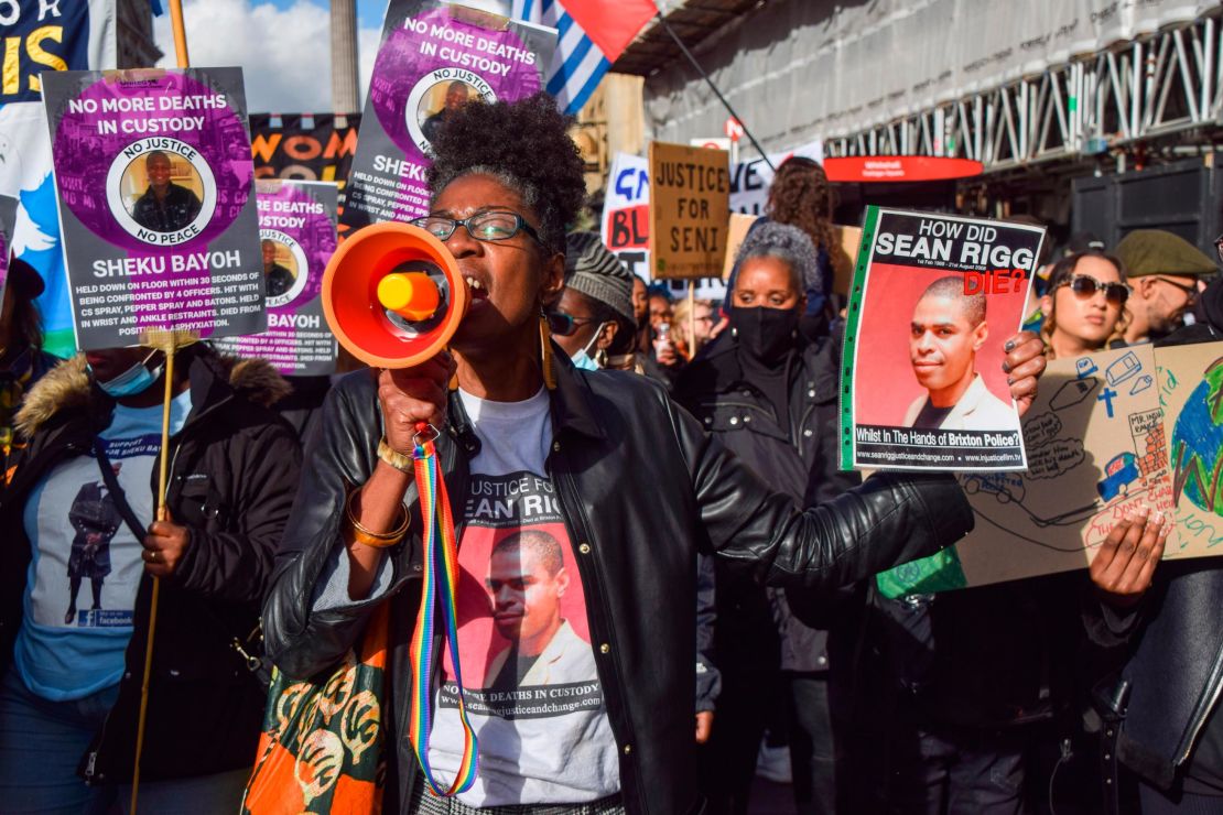 A protester holds a picture of Sean Rigg during a 2021 demonstration in London.