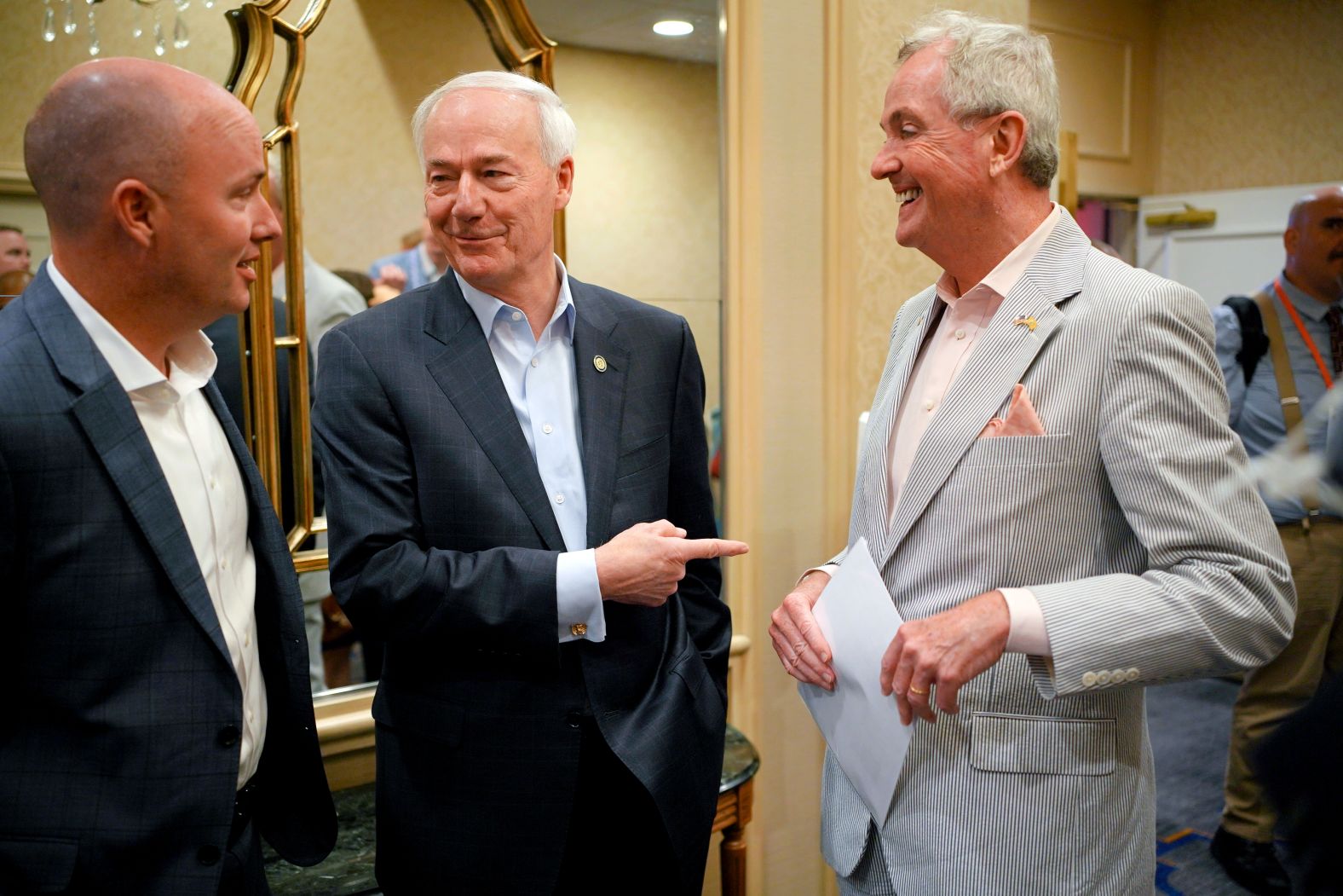 Utah Gov. Spencer Cox, left, and Hutchinson chat with New Jersey Gov. Phil Murphy at the National Governors Association meeting in Portland, Maine, in July 2022.