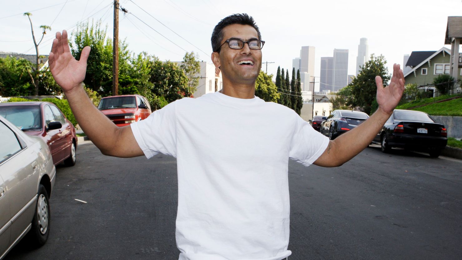 Francisco "Franky" Carrillo gestures while posing for a portrait on a street overlooking downtown Los Angeles on March 16, 2011. 