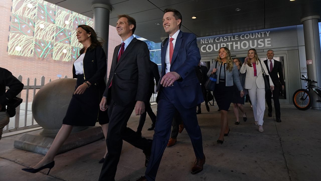 Davida Brook, left, Justin Nelson, second from left, and Stephen Shackelford, attorneys for Dominion Voting Systems, exit the New Castle County Courthouse in Wilmington, Delaware, on Tuesday.