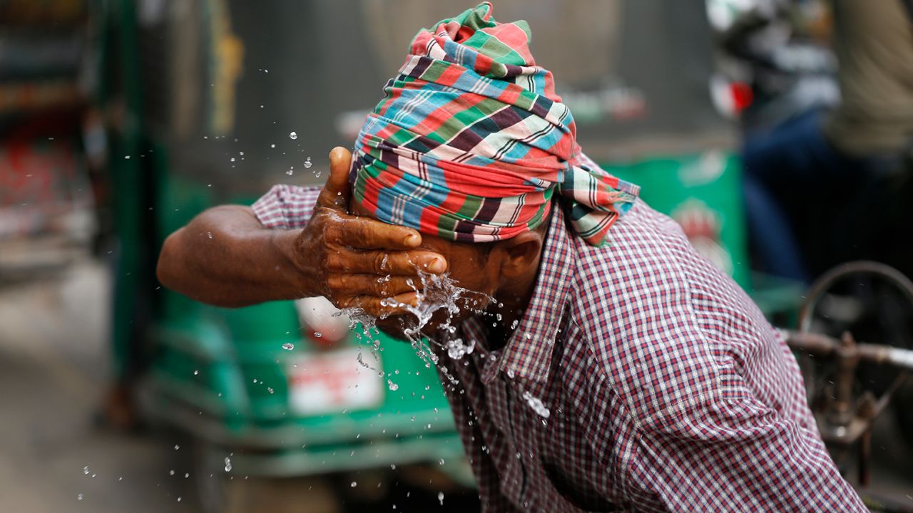 A rickshaw puller splashes water on his face to cool off during a heat wave in Dhaka, Bangladesh on April 16.