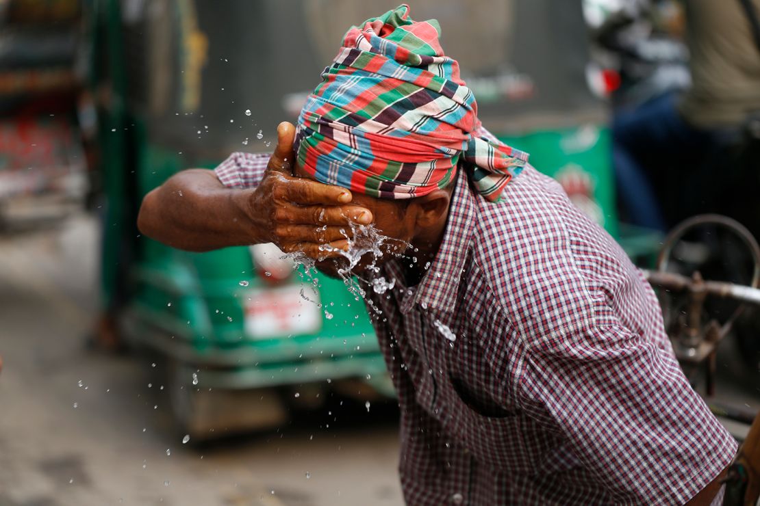 A rickshaw puller splashes water on his face to get relief during a heatwave in Dhaka, Bangladesh on April 16.