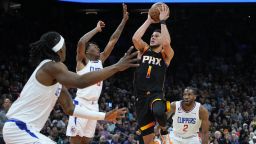 Phoenix Suns guard Devin Booker (1) shoots against the Los Angeles Clippers during the second half of Game 2 of a first-round NBA basketball playoff series, Tuesday, April 18, 2023, in Phoenix. (AP Photo/Matt York)