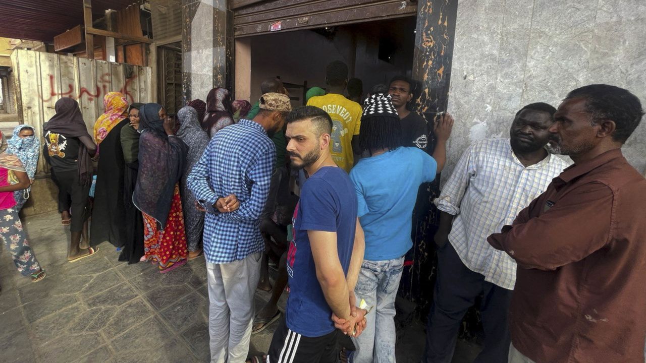 People gather to get bread in Khartoum amid the violence.