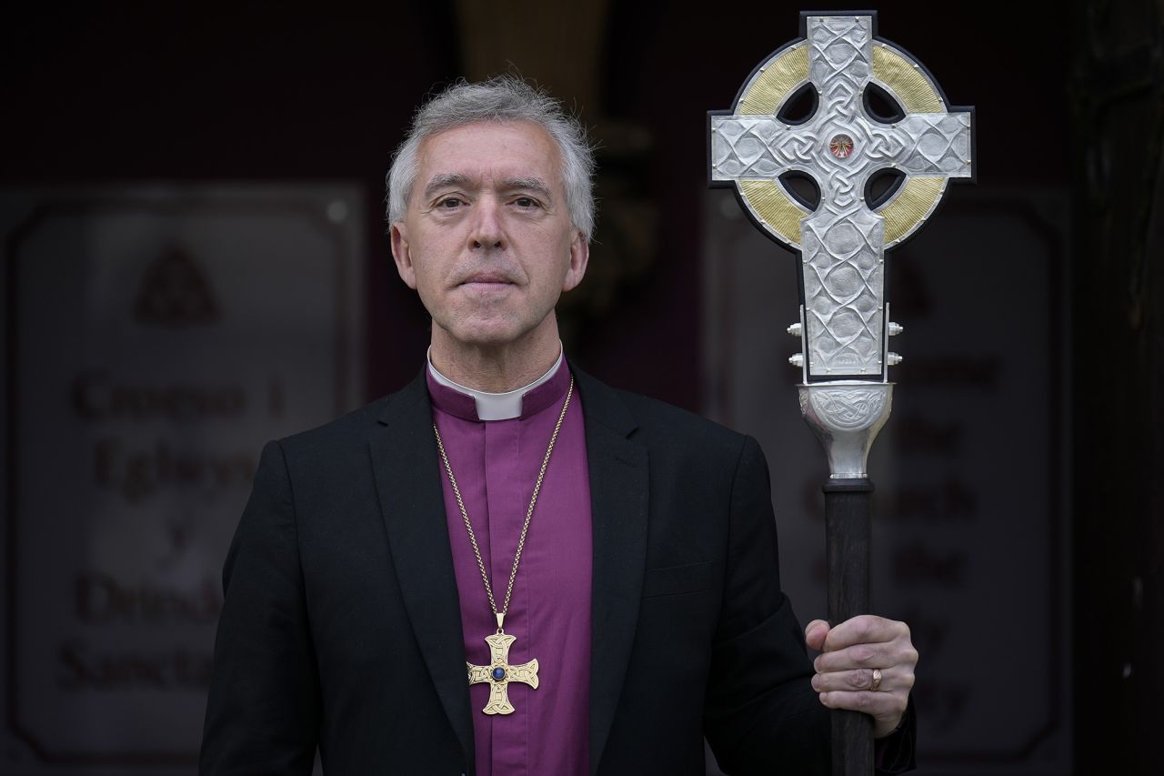 Archbishop of Wales Andrew John poses with the Cross of Wales at the Holy Trinity Church in Llandudno.