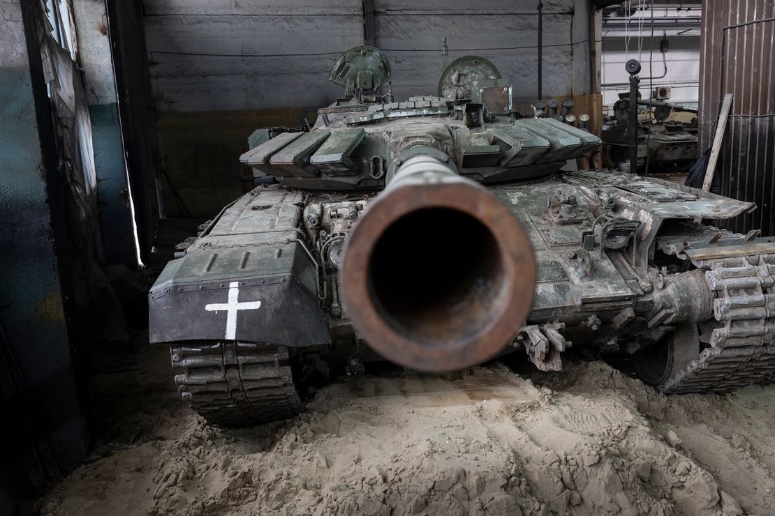A captured Russian T-72B3 tank awaits repairs on February 13, 2023, at a warehouse in eastern Ukraine. 