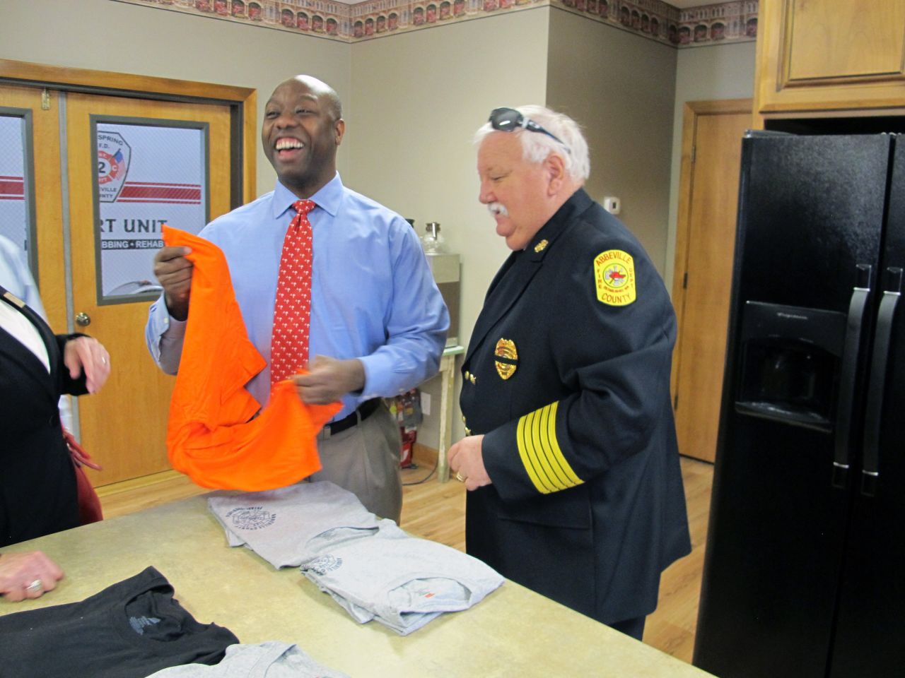 Scott accepts a T-shirt from Abbeville County Fire Marshal Dan Edatt during a visit in August 2013. Scott was finishing up a tour of all of South Carolina's 46 counties. He won an election the next year to serve the final two years of DeMint's term.